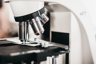 A close-up of a microscope in a laboratory.